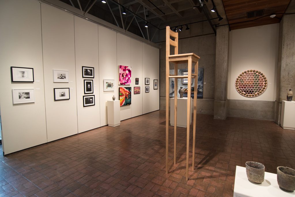 Annual Student Exhibition, 2018: installation view with artwork by Rachel Roser, Kaitlyn Irvine, Madison Lopez, Kristen Bennett, Thomas Shrieve, Haylee Canonico, Nikita Nenashev, Leah Caldwell, Hazel Coppola, Jenny Whitecar, Hari Jung, James Hadley, Nate Francis (chair), Macy Kennett, Julia Hummer, and Nikita Nenashev (left to right)